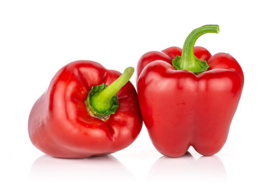 Group of two whole bulgarian red bell pepper isolated on white background
