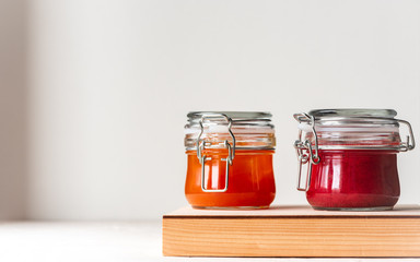 Two jars of jam on a white background. Copy space.