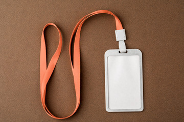 Empty security tag on brown background. Place for text, layout.