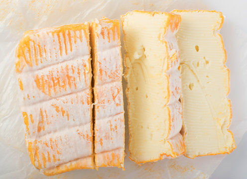Cheeseboard with Sliced Yellow Limburger Cheese Top View