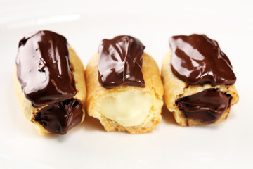 Traditional French dessert. Eclair with chocolate icing. Pastery concept with chocolate eclair