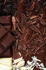 chocolate in diffrent color. milk, dark and white chocolate bars on table