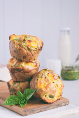 Freshly baked muffins with spinach, sweet potatoes and feta cheese on white background. Healthy food concept. Savory pastry.