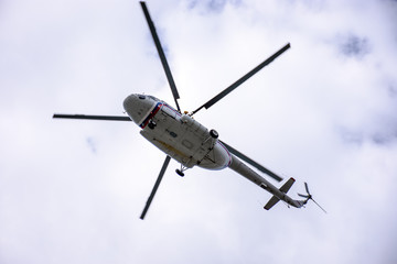 A large helicopter is flying in the blue sky