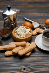 Ingredients for cooking tiramisu - Savoiardi biscuit cookies, mascarpone, cream, sugar, cocoa, coffee and egg