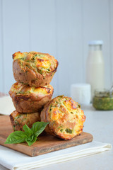 Freshly baked muffins with spinach, sweet potatoes and feta cheese on white background. Healthy food concept. Savory pastry.
