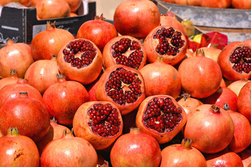 Close detail of Pomegranates on the counter of a street vendor with pomegranate juice in historical center of Trapani, Sicily Italy