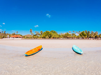 Orange boat, blue On the beach in summer.