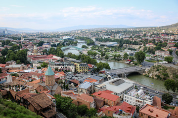 Fototapeta na wymiar View of the city from the observation deck. The capital of Georgia is Tbilisi. Old city. The Kura River. Red roofs, low buildings. Panorama, architecture, urban