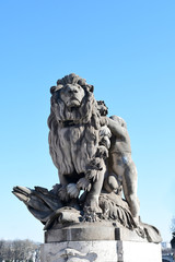 PARIS-FRANCE-FEB 24, 2019: Boy and Lion, one of the statues on Alexandre III bridge in Paris, France. Boy and Lion.
