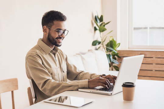 Men student working on computer. Businessman using laptop at home. Internet marketing, freelance work, online education concept