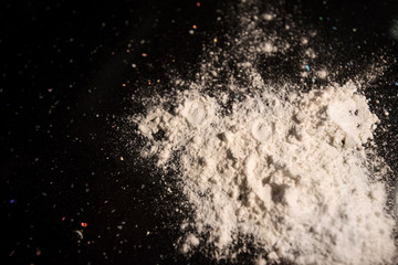 Top view of flour on dark background on kitchen table. Concept of baking pastry