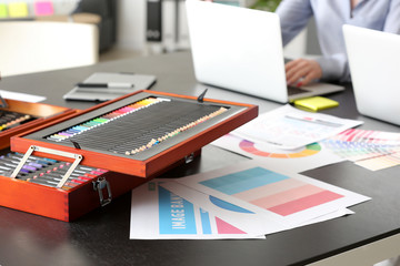 Set of color pencils on table of designer in office