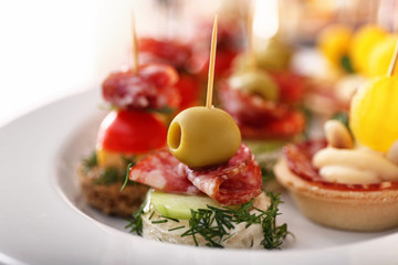 Tasty canapes on plate, closeup