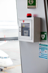 defibrillator attached to the wall at the airport