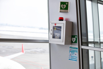 defibrillator attached to the wall at the airport