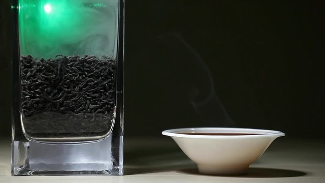 Black Hot Chinese tea cup green smoke wooden table dark background nobody hd footage 