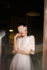 Model posing in a wedding dress with blindfold. Advertising of wedding dresses