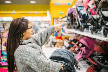 Pregnant woman in shop, wheelchair department