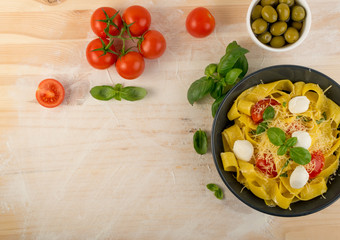 Yellow italian pasta pappardelle, fettuccine or tagliatelle