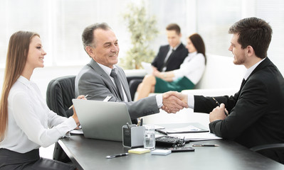 handshake business people behind a Desk in the office