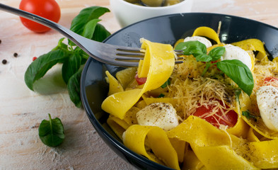 Yellow italian pasta pappardelle, fettuccine or tagliatelle