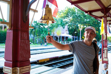 man beats the bell at the station Hua hin, Thailand