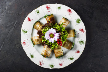 Appetizer of stuffed eggplant with salted salmon decorated with lettuce and flower