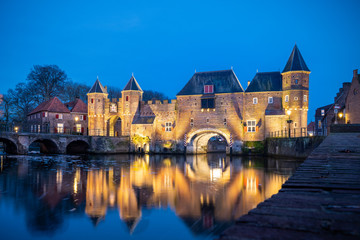 Medieval city gate as entrance over a flowing river; eem,  in Amersfoort holland