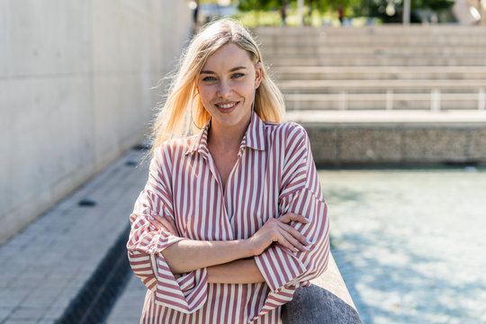 Portrait Of Smiling Blond Woman Wearing Striped Shirt