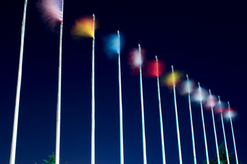 Long exposure flags. Waving flags on the wind at night. Different countries flags are on the...