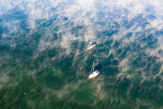 Germany, Bavaria, Upper Bavaria, Fuenfseenland, St. Heinrich near Muensing, Aerial view of Lake Starnberg, sailing boats and morning fog