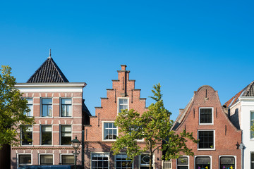 row stepped gable houses in Alkmaar, The Netherlands. Against blue sky