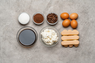 Ingredients for cooking tiramisu - Savoiardi biscuit cookies, mascarpone, cheese, sugar, cocoa, coffee and egg