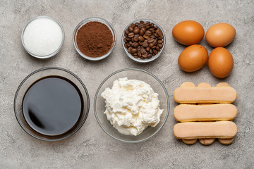 Ingredients for cooking tiramisu - Savoiardi biscuit cookies, mascarpone, cheese, sugar, cocoa, coffee and egg
