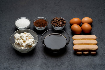Ingredients for cooking tiramisu - Savoiardi biscuit cookies, mascarpone, cheese, sugar, cocoa, coffee and egg