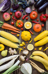 Yellow, orange, red, purple fruits and vegetables on wooden background.  Healthy food. Multicolored...