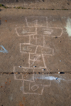 Hopscotch Board Drawn With Sidewalk Chalk On Gray Pavement Background