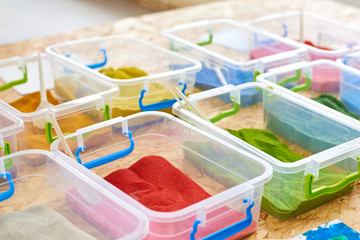 Multi-colored sand for drawing in plastic containers