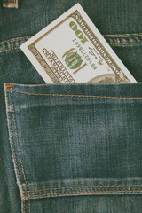 Concept: I have money! One hundred US Dollar in jeans pocket. Retro styled image.
