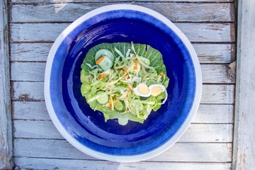 salad of all vegetables in a blue plate