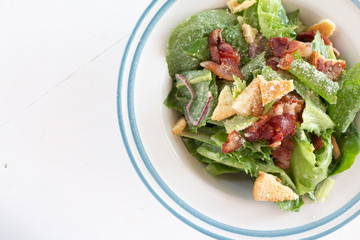Closeup of healthy Caesar salad with croutons and Ham sliced