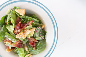 Closeup of healthy Caesar salad with croutons and Ham sliced