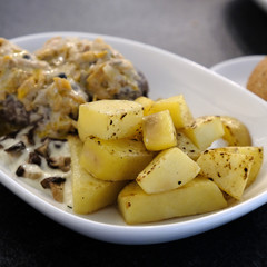 Boiled potatoes in a plate with meat. Food photography