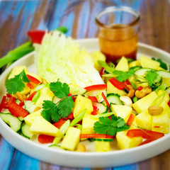 Thai pineapple salad with pepper, cucumber, lettuce, cilantro and dressing