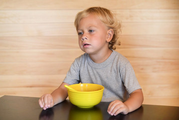Cute baby child eating healthy food. Portrait of happy kid boy.