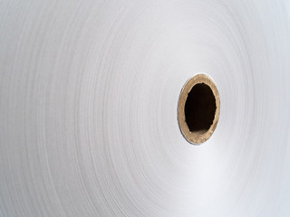 Newsprint roll in the production shop of printing house. Set of layers of white paper