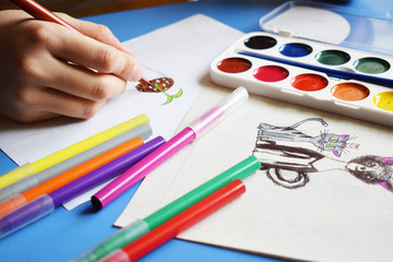 Watercolor,felt-tip pens on a white background.The child draws pictures.