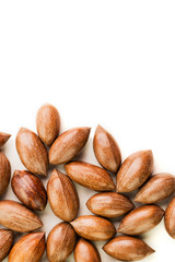 Not cleaned pecan nuts in the shell isolated on white.