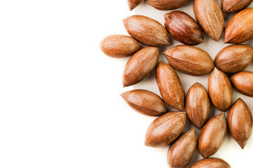 Not cleaned pecan nuts in the shell isolated on white.